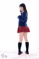 Student in uniform looking back wearing plaid skirt